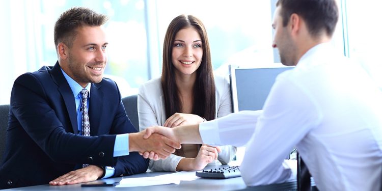 businessman shaking hands to seal a deal with his partner